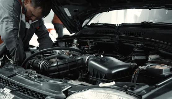 Technician repairing a car engine — Engine Repair